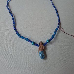 Black-haired dark skin Mermaid Clay Pendant on  bright  blue ball beaded necklac